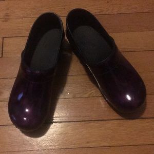 Purple Sanita clogs.